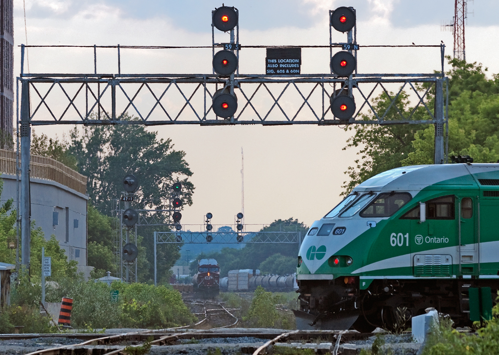 The last revenue GO train clears the diamond at West Toronto while in the background CP 9840 East CP 255\'s train sits back on track 2 awaiting the clear signal to proceed east to Toronto Yard.