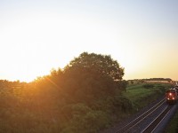 The first train of the day in Lovekin at 06:24 CN 2294 and CN 2546 lead this westbound freight to Mac Yard as the sun slowly starts to creep over the trees.