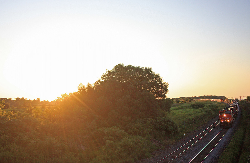 The first train of the day in Lovekin at 0624 CN 2294 and CN 2546 lead this westbound freight to mac yard as the sun slow starts to creep over the trees.