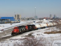 In a rarely-caught move, CN local 543 with GP9RM's 4112 and 7007 takes the industrial lead tracks to CN's Mimico Yard, heading past the wye and south end of VIA's Toronto Maintenance Centre. Retired LRC's, RDC's and stored garbage gondolas litter the yard, and past the VIA fueling building is the CN Oakville Sub's mainline trackage.
