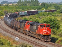 A pair of \'line backers\', CN 8866 and 8898 lead 369\'s train through the curve at Bowmanville. 1736hrs.