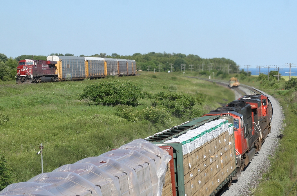 CP 112\'s DPU shoves through Lovekin at 60 MPH as CN 376 attempts to keep pace passing through a Rule 42.