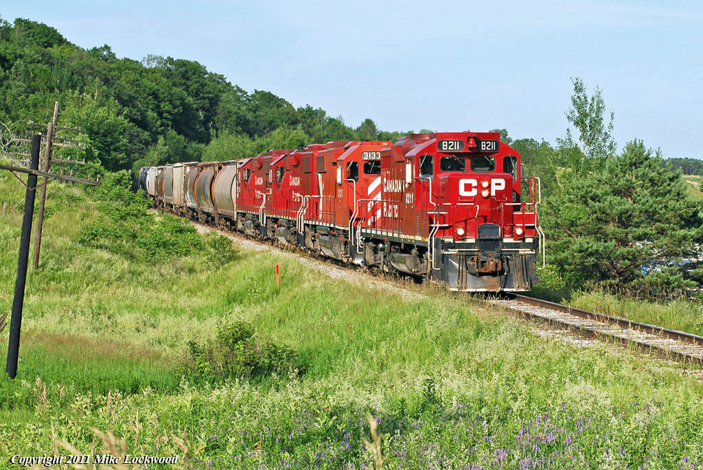 The Havelock approaches Simcoe Street North with T07\'s 29 cars. Power is CP 8211, 3133, 3045, and 3114, 1838hrs.