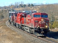 CP 9626, 3032, and 9571 lead 234\'s train through the s-curve at Newtonville. The 3032, seemingly fresh out of the shop and in new paint, has the dubious distinction of powering the last CP train out of Goderich, Ontario. 1220hrs.