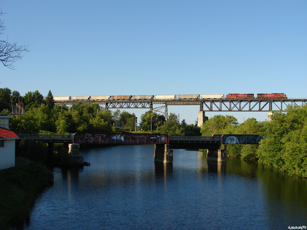 CP 9671 North crosses the ancient trestle in Parry Sound, this 615-027 consisted of a couple 9600\'s, and 75 phosphate loads from the CSX as the sun comes up on a beautiful morning in Parry Sound!
