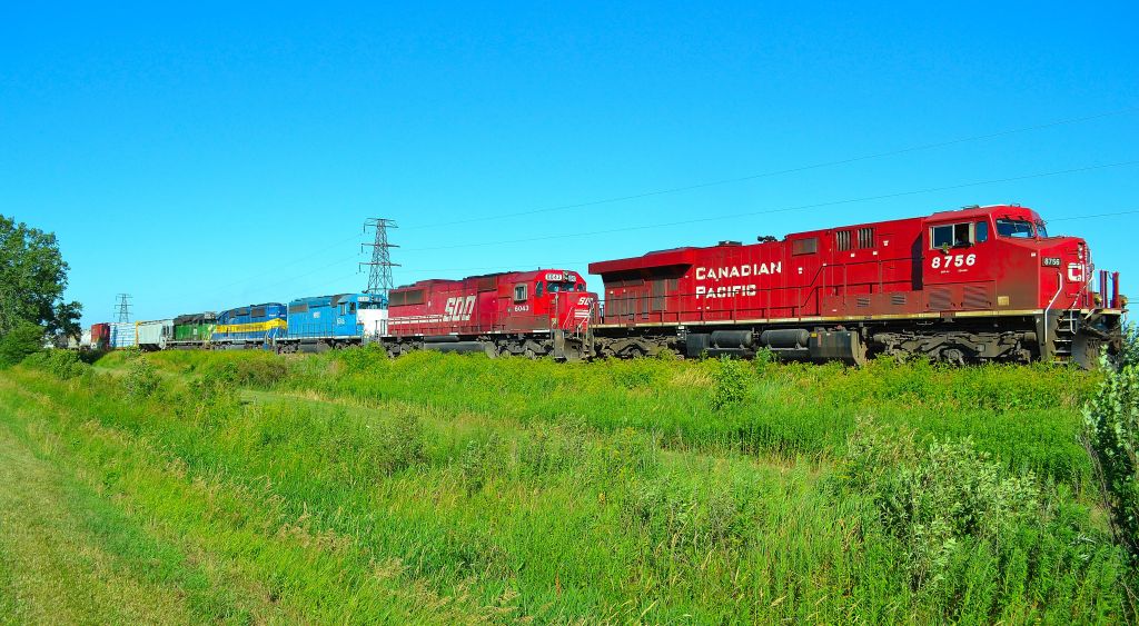 \"Lots of colour\" CP 245 led by CP 8756 (ES44AC), SOO 6043 (SD60), NREX 6309 (SD40-2), DME 6097 (SD40-3) & CITX 3026 (SD40-2 ex BN) heads westbound at mile 70.6 of the CP Windsor Sub at 6:02pm