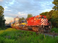 CP 626 led by CP 6067, ICE 6450, CITX 3099 & HLCX 8089 (all SD40-2\'s) hooked elephant style, head eastbound thru Thamesville at 6:38am at the mile 49.09 crossing. 7-31-2011