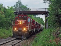 8211 heads up todays T07 along with 3114 3045 3133 with a load of 31 cars.Heading deep into the woods at Tapley Ontario.