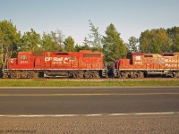 3111 with the dual flag scheme and 8207 lead T08 into the setting sun outside Havelock Ontario.