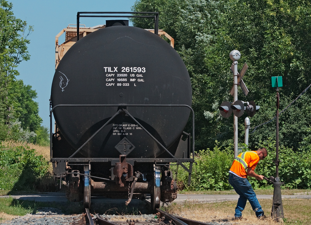 Realigning  the switch is what the conductor on the Orangeville Brampton Railway is doing after setting off 8 cars and lifting 2 on the CPR interchange track in Streetsville.