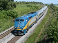 With a friendly wave and a few blasts of the horn, VIA 908 cruises through the countryside south of Newcastle, Ontario.