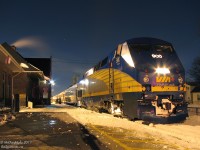 On a frigid winter's night, VIA train #89 makes its brief scheduled stopover at Brampton Station. P42 class-unit 900 leads the charge from Toronto to Brampton, Georgetown, and eventually Sarnia this evening. The reddish-purple light reflecting on the lead unit comes from the pair of dual signaltowers just past the station, both lit up red but with a single green awaiting 89's highball westward.