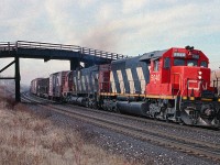 An SD40 and an M-630 head up train 390 passing under the bridge at Lovekin, between Clarke and Newtonville on the Kingston sub in March 1990