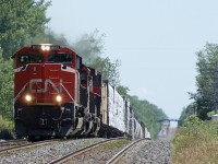 SD70M-2 8012 emerges from the telephoto-exagerated dip on the Kingston sub between Brighton and Colborne with train 369. This part of the Kingston sub is known as "the dangers." Its undulating profile has led to many a pulled drawbar or broken knuckle.