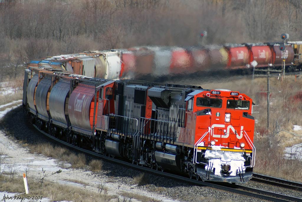 CN #121 with a huge cut of empty grain cars at the head-end, rounds the curve at Bowmanville