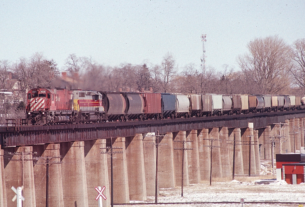 CP MLW C630-M 4508 leads a leased Algoma Central SD40 over the Ganaraska viaduct in Port Hope on a sunny Sunday afternoon in March 1985. Note the still existing former Port Hope, Lindsay and Beaverton tracks at the bottom of the picture.