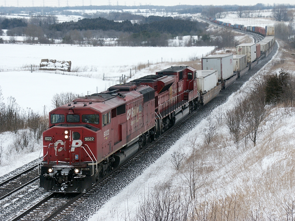 CP #153 is detouring on the CN Kingston sub due to a wreck on the CP at Garden Street in Whitby. Seen approaching Newtonville Rd, two locomotive models (SD40-2F, SD90) foreign to CN are the power.