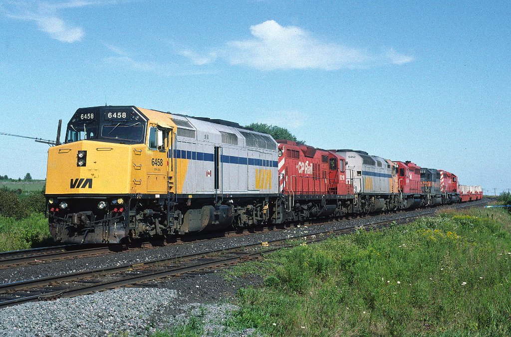 VIA F40PH-2 6458 leads an eclectic selection of units west at Lovekin siding, CP Belleville sub, on a September Sunday in 1992.