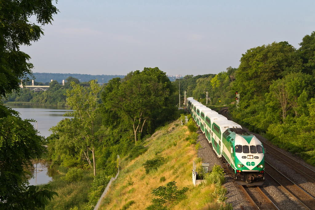The early morning sun washes over Go Train 496 from Hamilton to Toronto behind unit 611 as she passes through Bayview Junction.  Hamilton Bay is in the background.