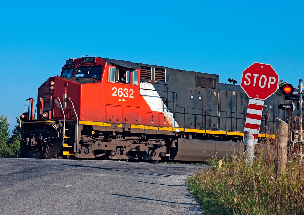 A rather junky looking C44-9 leads train 393 through Stewarttown and the grade crossing on 15th side road.