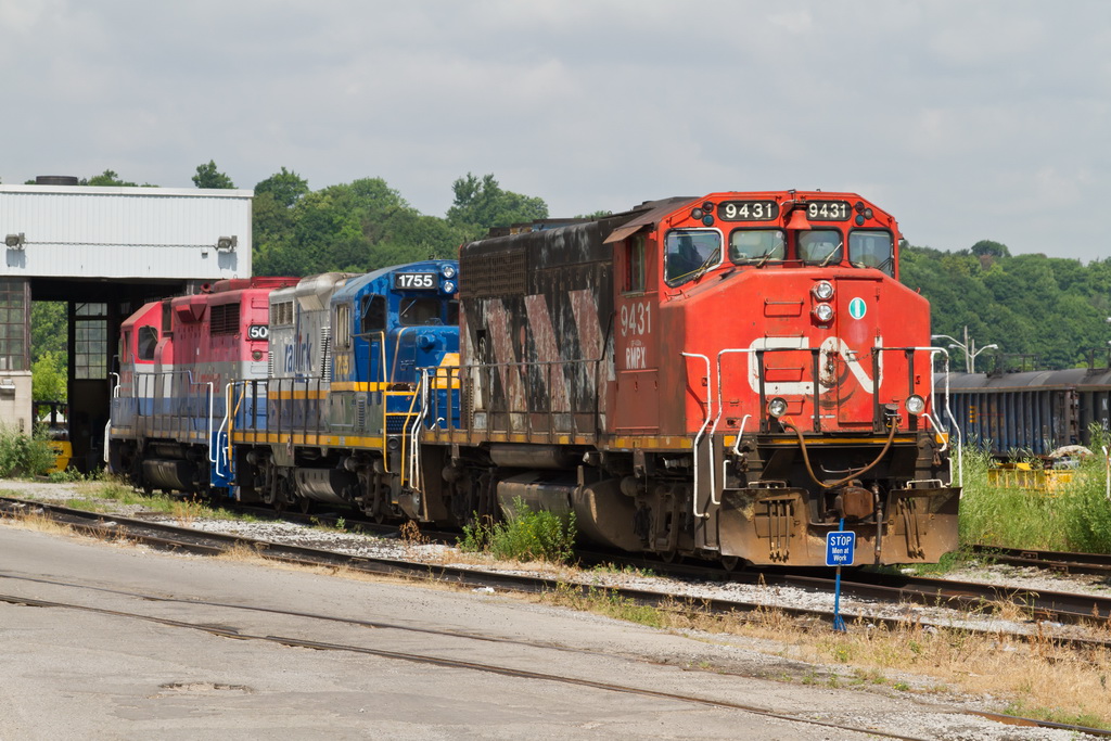RMPX 9431 heads up a colourful consist at the Railink shop in Hamilton