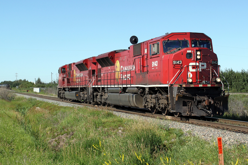 CP SD90MAC 9143 and 9154 head north on the CP Scotford sub in east Edmonton.  They have just crossed the diamond on the CN Camrose sub.  They are probably heading to pick up a train at CP\'s Clover Bar Yard.
