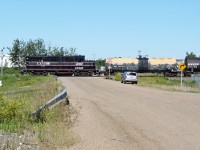 CANDO Contracting GP9 #4014 heads south from the Esso Strathcona Refinery on to the CN Camrose sub with a cut of tank cars, probably to be deposited at the new storage siding  about 8 miles south.
