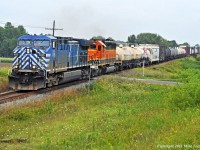 A blueberry and a pumpkin lead 235\'s train past MP 166 of the Belleville Sub. CEFX 1035 and HLCX 6844. 1330hrs.