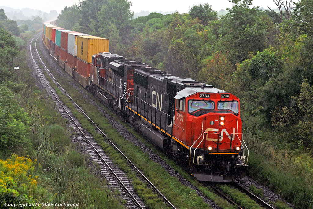 The rain should really help with the climb to Newtonville. CN 5734 and 8909 take 149 west. 1503hrs.