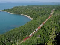 Located 100 miles east of Thunder Bay, its a long way to go for shot. But it was worth it, as the stars aligned with a perfect morning departure of train 112-29 at Thunder Bay. By the time it got to Kama Bay, the old gravel pit was in full sun, the trees a deep green and gorgeous blue Lake Superior. 
