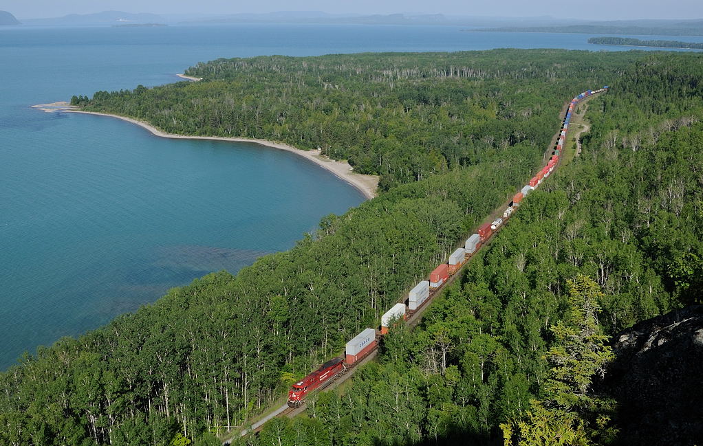 Located 100 miles east of Thunder Bay, its a long way to go for shot. But it was worth it, as the stars aligned with a perfect morning departure of train 112-29 at Thunder Bay. By the time it got to Kama Bay, the old gravel pit was in full sun, the trees a deep green and gorgeous blue Lake Superior.