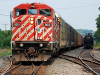 CP 441 with a pair of red barns shoves a long cut of empty autoracks into Coakly siding for the OSR to pick up. 