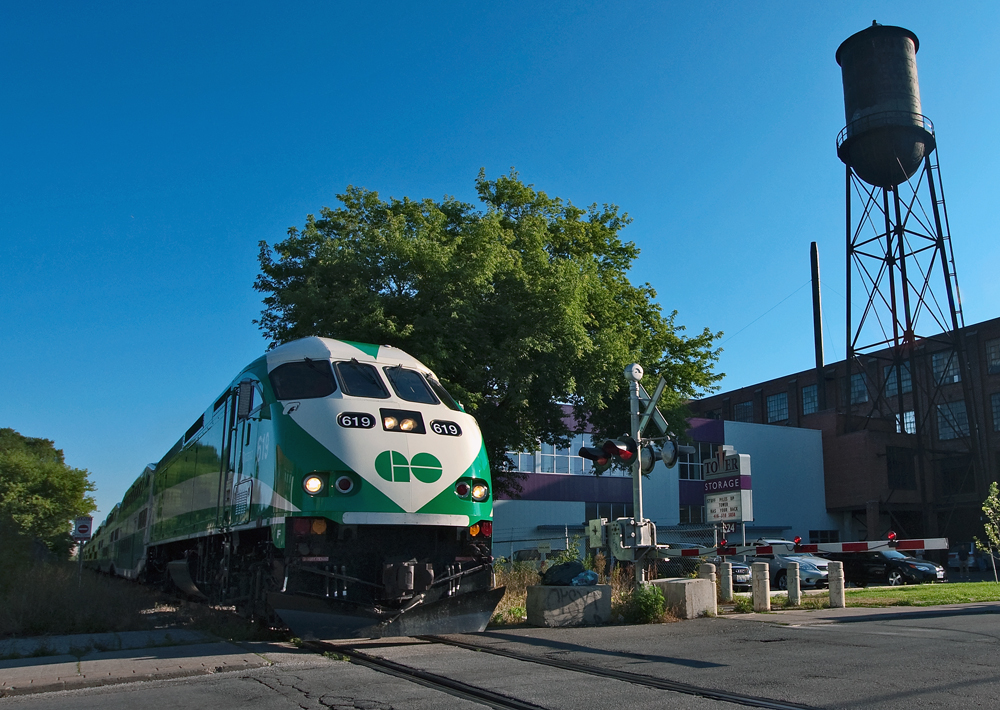 The large Canadian General Electric water tower, a symbol to the glory day of industries that littered the junction triangle in the west end of the city, GO Train 804 is on the last leg of it\'s journey to Toronto and is seen here crossing Wallace Ave.