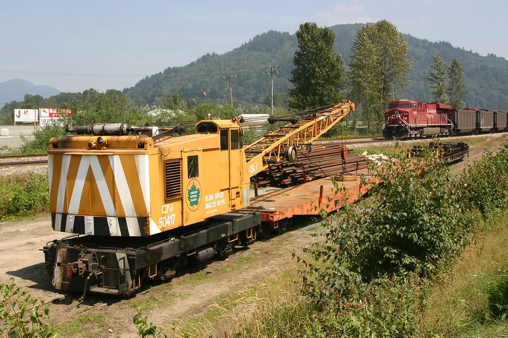 A former Great Slave Lake district crane sits in the backtrack at Arnold, BC.  Two CP coal trains can be seen in the background, held up by delays crossing the river back to CPR trackage
