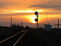Ballast regulator works on the siding at Rotave during a beautiful sunrise.