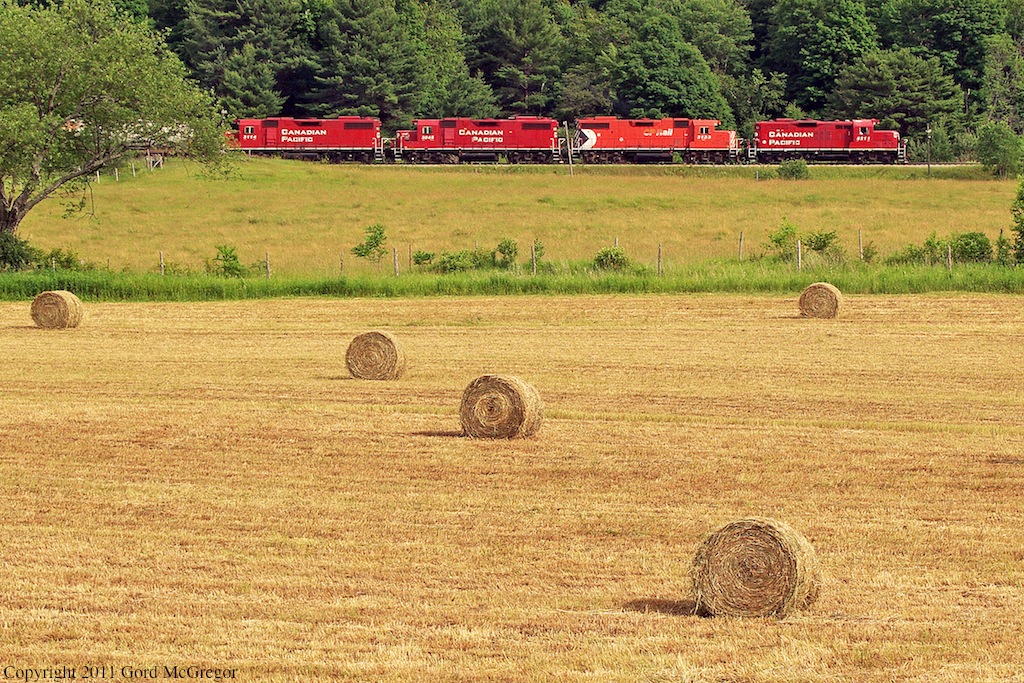 Its Canada Day,8211 leads todays T07 past fresh hay bails outside Pontypool.along for the ride is 3133,3045 and 3114.