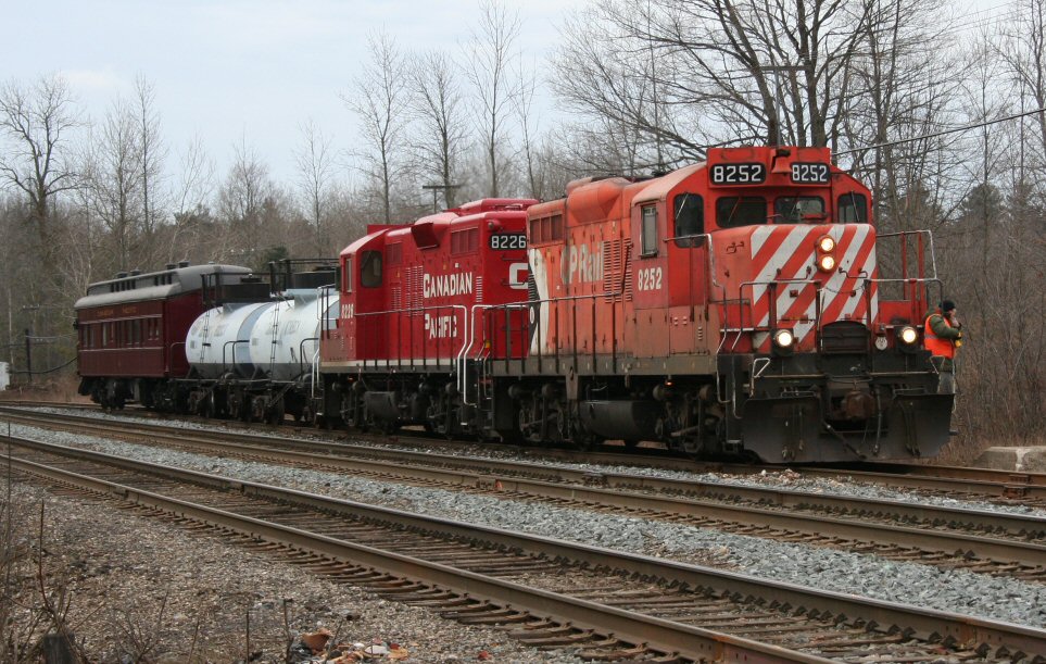 A modern mixed train? A pair of CP GP9us handle a unique move consisting of an pair of old tank cars and a former CP business car which are being delivered to the Ontario Southland interchange at Guelph Junction. The tanks are retired former Canada Starch cars that were stored for several years in Port Stanley, and acquired by OSR for use as weed spraying cars. The business car is privately owned by one of OSR\'s engineers and assistant managers.