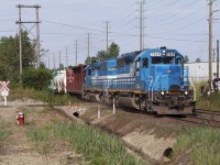 GEXR 432 (K43231 XX to CN), a GEXR transfer of traffic from Stratford-Kitchener to CN Mac Yard pounds the diamond at Brampton on this hot summer morning.