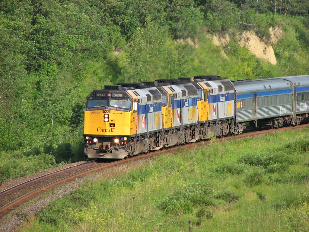 Via Canadian accelerates around the curve for a station stop at the now long gone North Brandon Via shed.