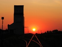 The rising sun on a prairie branchline. 