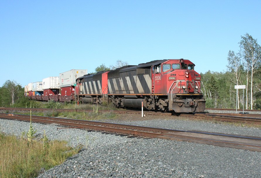 A southbound CN intermodal rattles across the diamond crossing with Canadian Pacific\'s Parry Sound subdivision at St. Cloud, a few miles geographically southeast of Sudbury, ON.