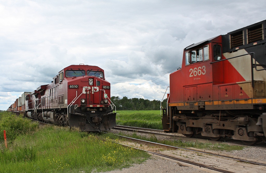 Two companys moving Canada one train at a time. CP 8510 with 116 waits for hot hot CN 111 to roar by.