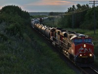 CN 312 with 2325 and 5640 try to haul a fairly long train out of the valley with the summer sun going down.