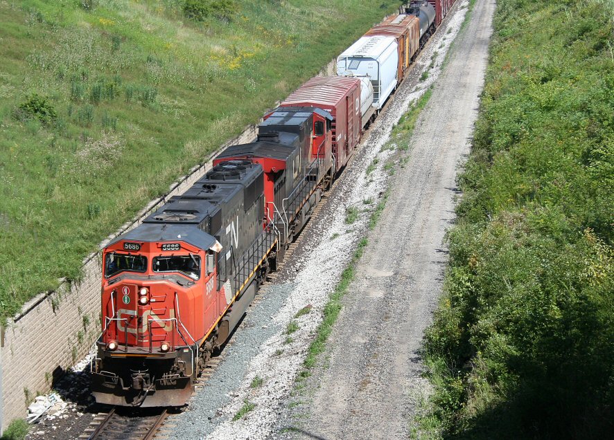 A southbound CN intermodal rattles across the diamond crossing with CP\'s Parry Sound subdivision a few miles geographically southeast of Sudbury, ON.