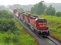 A few notable SD40-2\'s power the eXpressway east about a mile west of the Port Hope siding as the rain eases. STLH 5560 leads CP 5420 and 5730. 1509hrs.