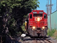 With a lift from National Steel Car and US Steel, CP's TH11 job trundles back to Kinnear at a blistering 10 MPH through the industrial part of Hamilton. 