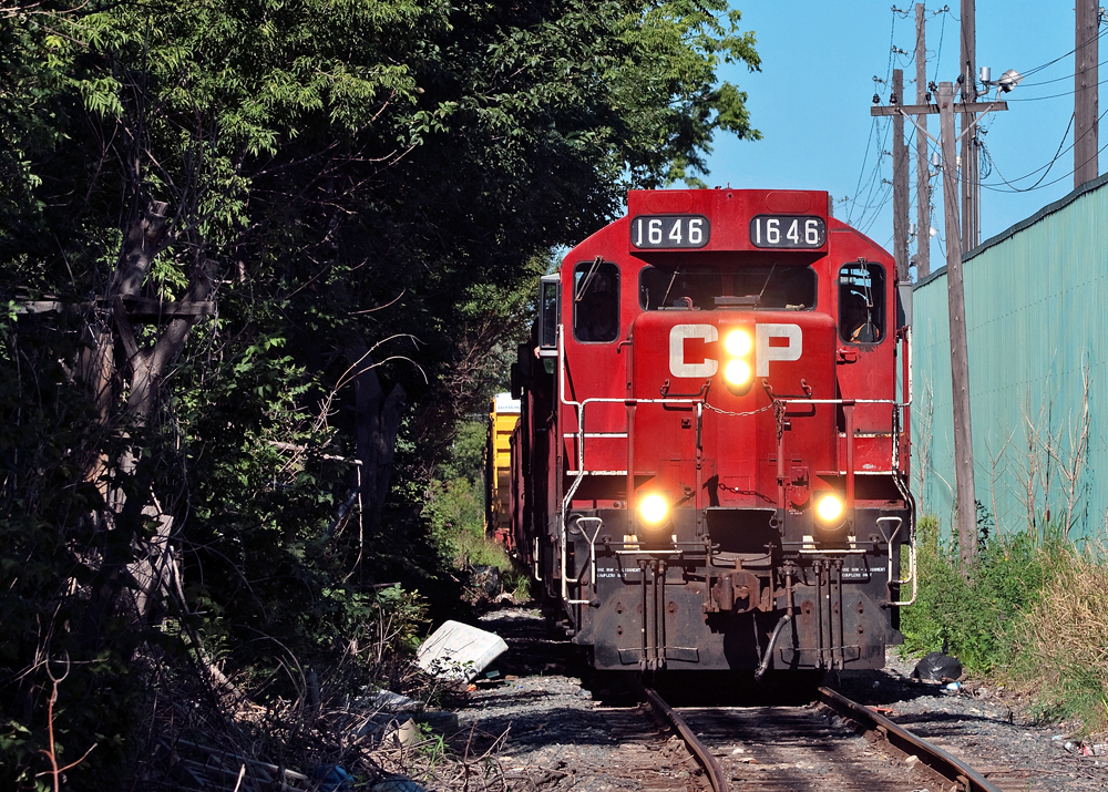 With a lift from National Steel Car and US Steel, CP\'s TH11 job trundles back to Kinnear at a blistering 10 MPH through the industrial part of Hamilton.