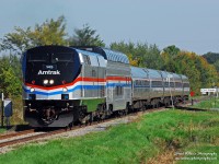 The annual fall foliage dome car addition to the Amtrak Adirondack train was complimented this year by its arrival in the Phase III paint. Amtrak also assigned the Phase III P42DC 145 to the Adirondack service to be mated with the dome car runs. On September 27, the Amtrak Adirondack train 68 is seen rolling south through Cantic, Quebec on Canadian National's Rouses Point Subdivision as it passes the switch to the CN Swanton Sub in splendid morning sun. Many more photos at http://steelwheelsphotography.com.