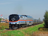 The annual fall foliage dome car addition to the Amtrak Adirondack train was complimented this year by its arrival in the Phase III paint. Amtrak also assigned the Phase III P42DC 145 to the Adirondack service to be mated with the dome car runs. On September 27, the Amtrak Adirondack train 68 is passing the Canadian Customs station - the train is still in Canada at this point, the photographer is in the US!. Many more photos at http://steelwheelsphotography.com.