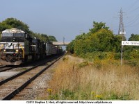 CN F328, a Norfolk Southern (CN Haulage agreement) detour train is remenicent of NS 328 of years past as it rolls by the Grimsby VIA station